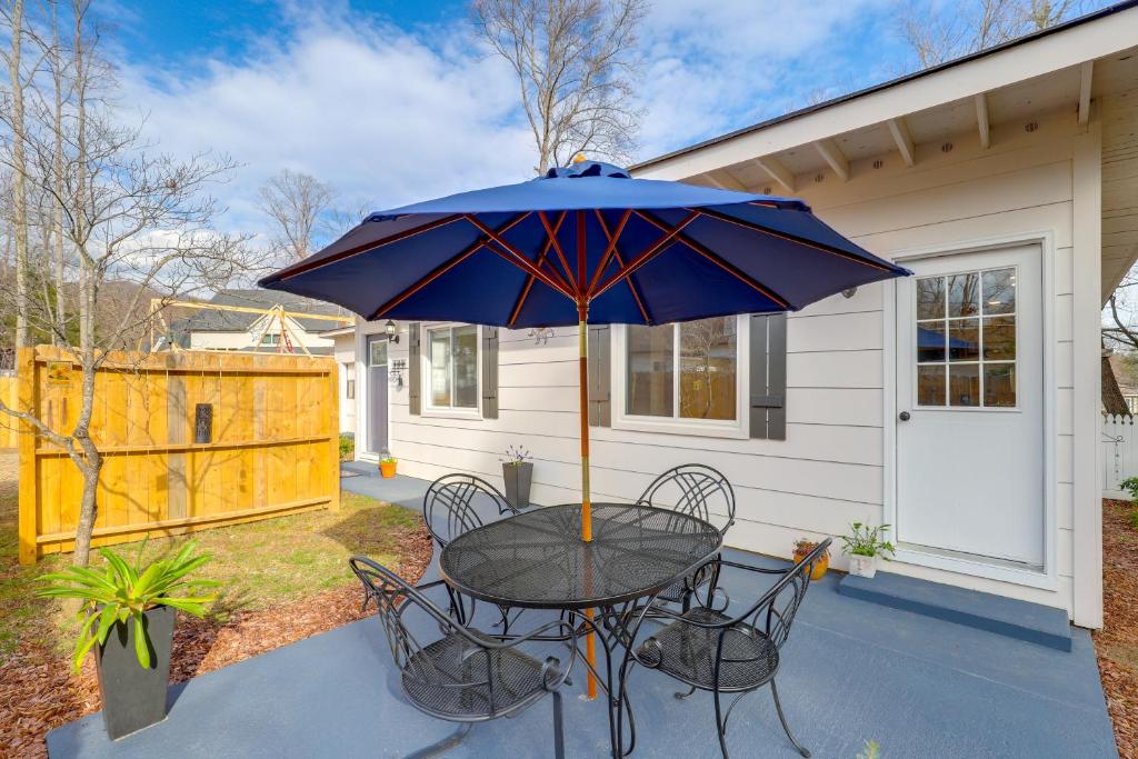 a table and chairs with an umbrella on a patio at Private Patio & Pond: Serene Black Mountain Escape in Black Mountain
