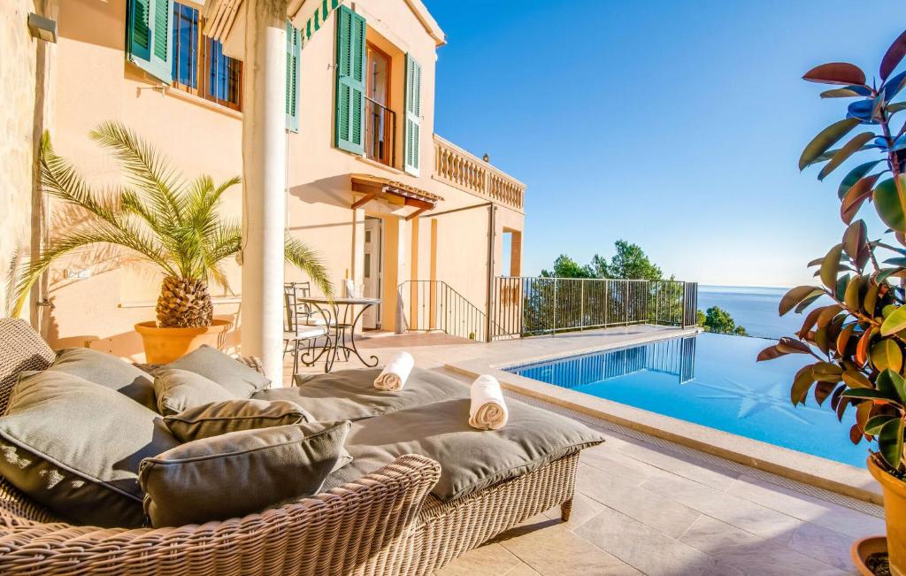 a patio with a couch and a swimming pool at Ventimar in Canyamel