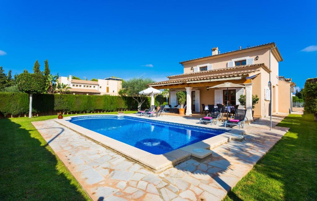 a house with a swimming pool in a yard at Gatoses in Sa Coma