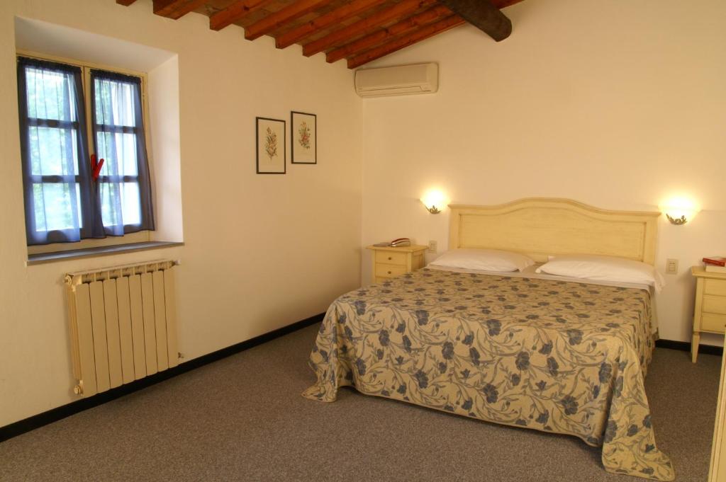 Postel nebo postele na pokoji v ubytování Hotel Calzaiolo