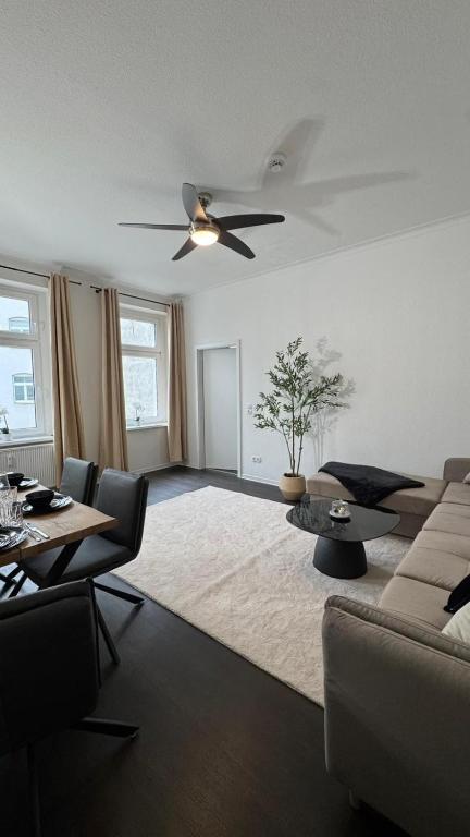 a living room with a couch and a ceiling fan at Paulus Living in Halle an der Saale