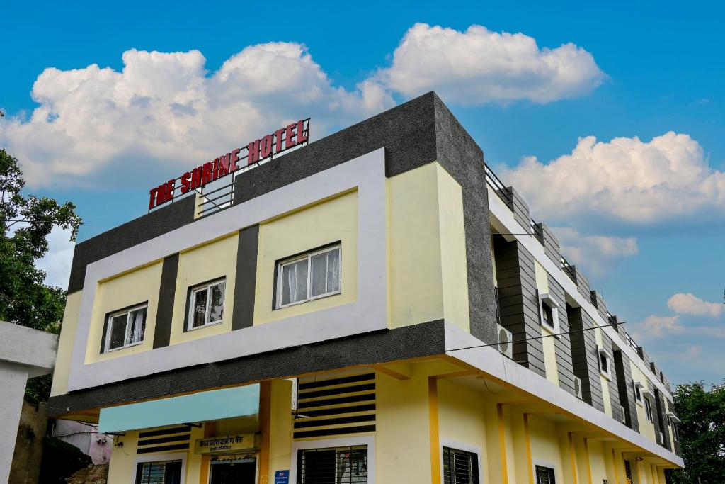 a building with a sign on top of it at The Shrine Hotel in Godarpura