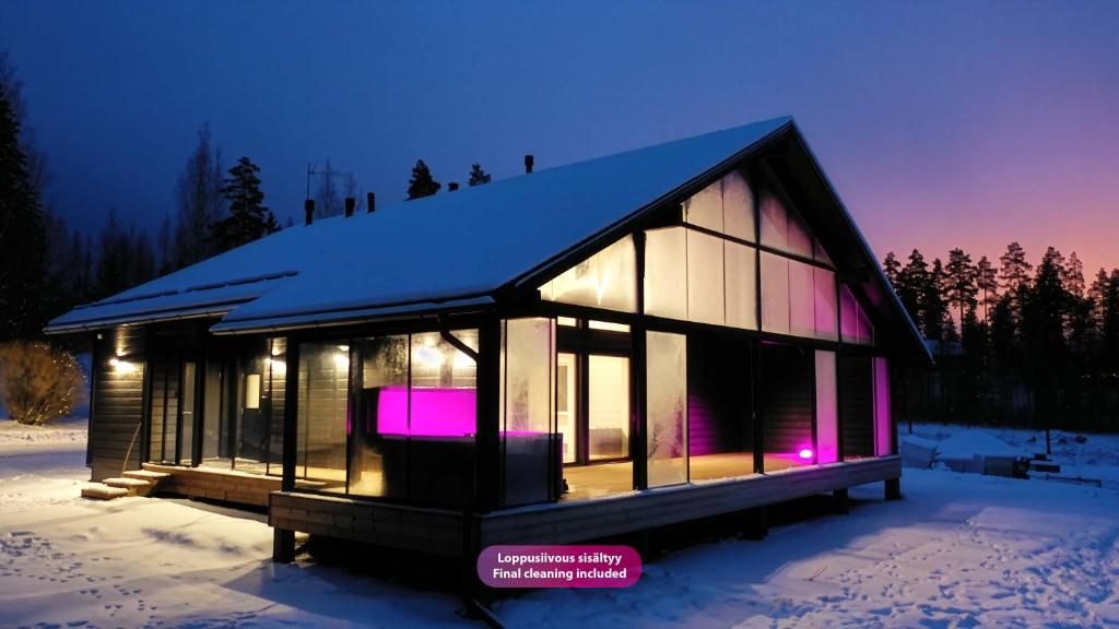 a small house in the snow at night at Villa Taipale - 10hlö, Himosranta in Jämsä