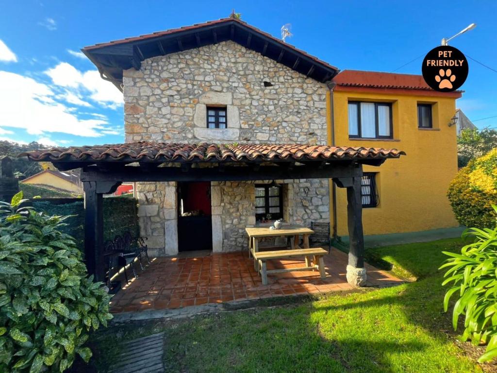 a house with a bench in front of it at Casa Lula 2 Pendueles Llanes AR-685-AS in Llanes