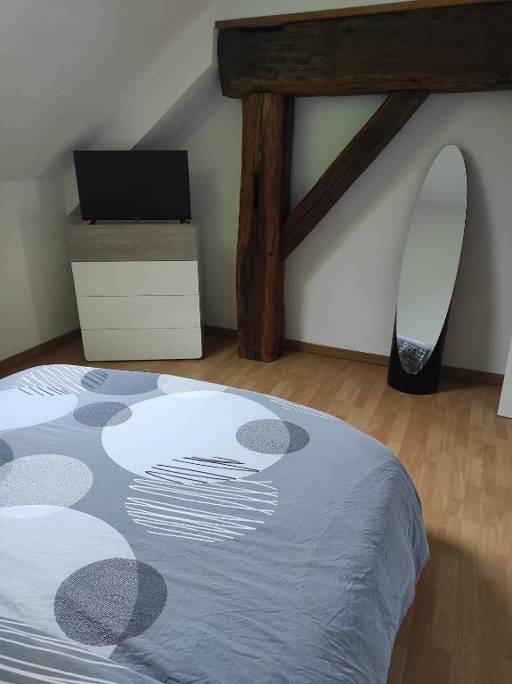 a bedroom with a bed and a surfboard on the wall at Maison en sortie d'autoroute A31 in Rolampont