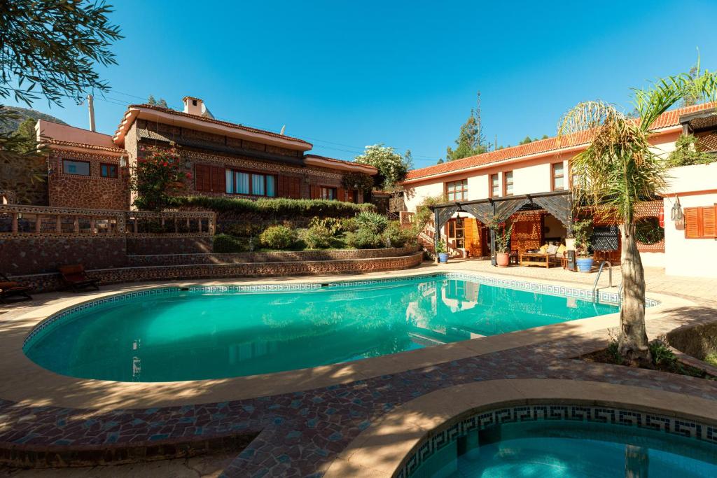 a swimming pool in front of a house at Dar Arraha Ouirgane in Ouirgane