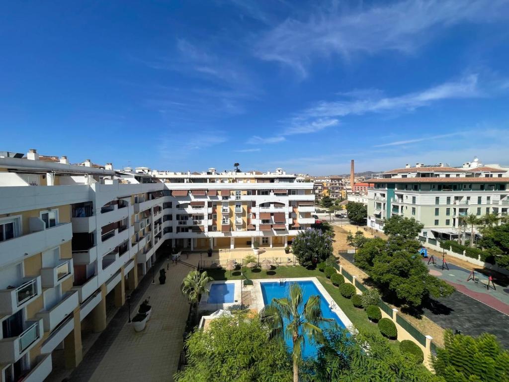 arial view of a building with a swimming pool at Terrasol Torrelitoral Ático 1 Dormitorio in Torre del Mar