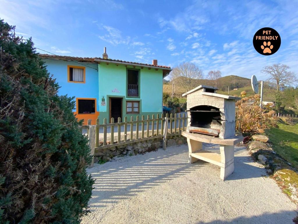 a house with a pizza oven in front of it at Casa El Marizal 1 Arriondas CA-1028-AS in Arriondas