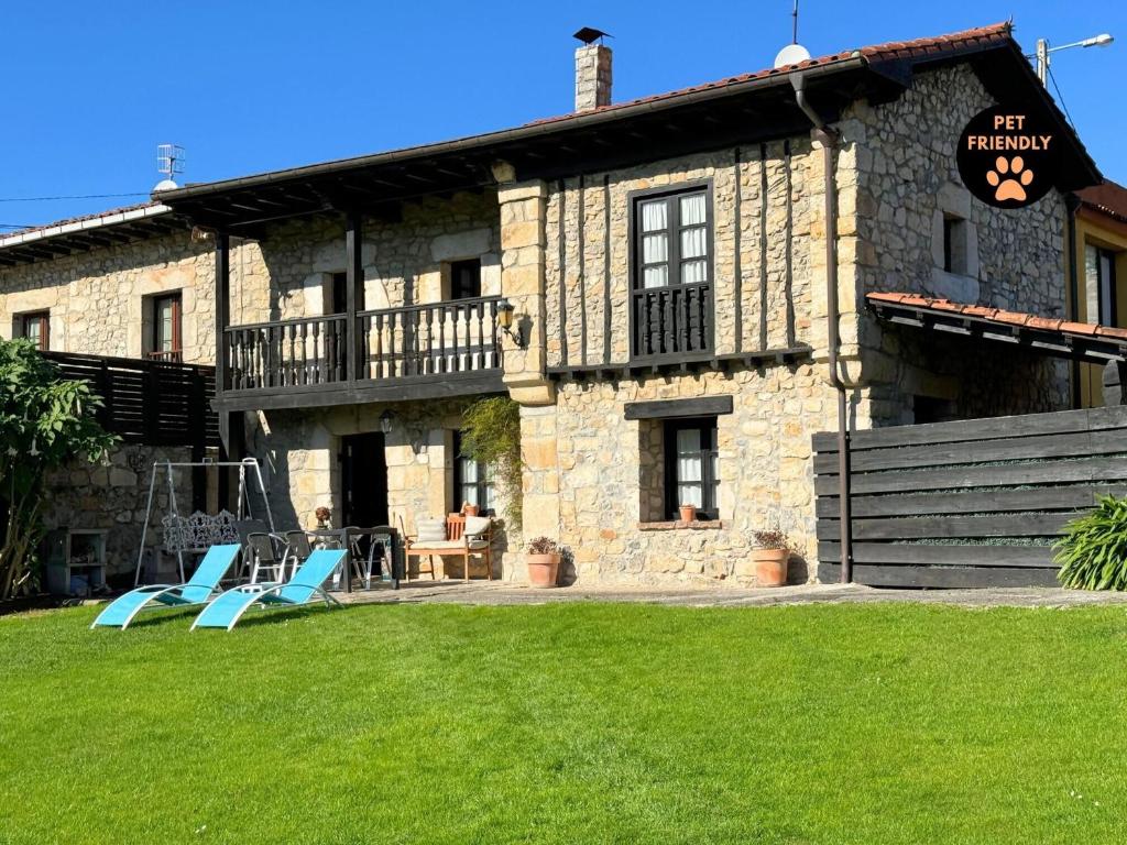 two blue chairs in front of a stone building at Casa Lula 1 Pendueles LLanes AR-685-AS in Llanes