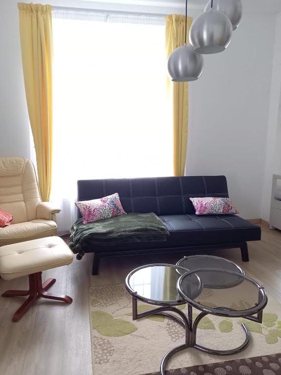 a living room with a couch and a coffee table at La maison de Yo in La Feuillée