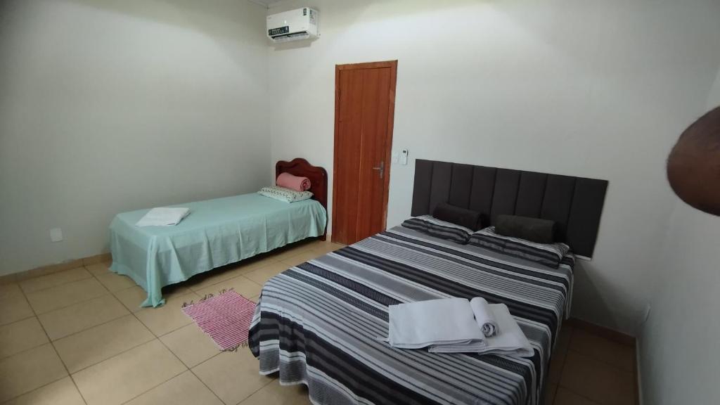 a room with a bed and a bed sidx sidx sidx sidx at Pousada Central in Montes Claros