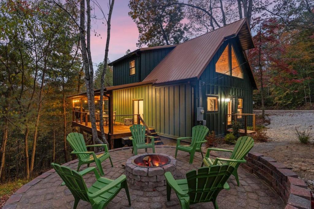 a tiny house with a fire pit in front of it at Anchor Point- Hot Tub, Firepit, Ping Pong in Rogers