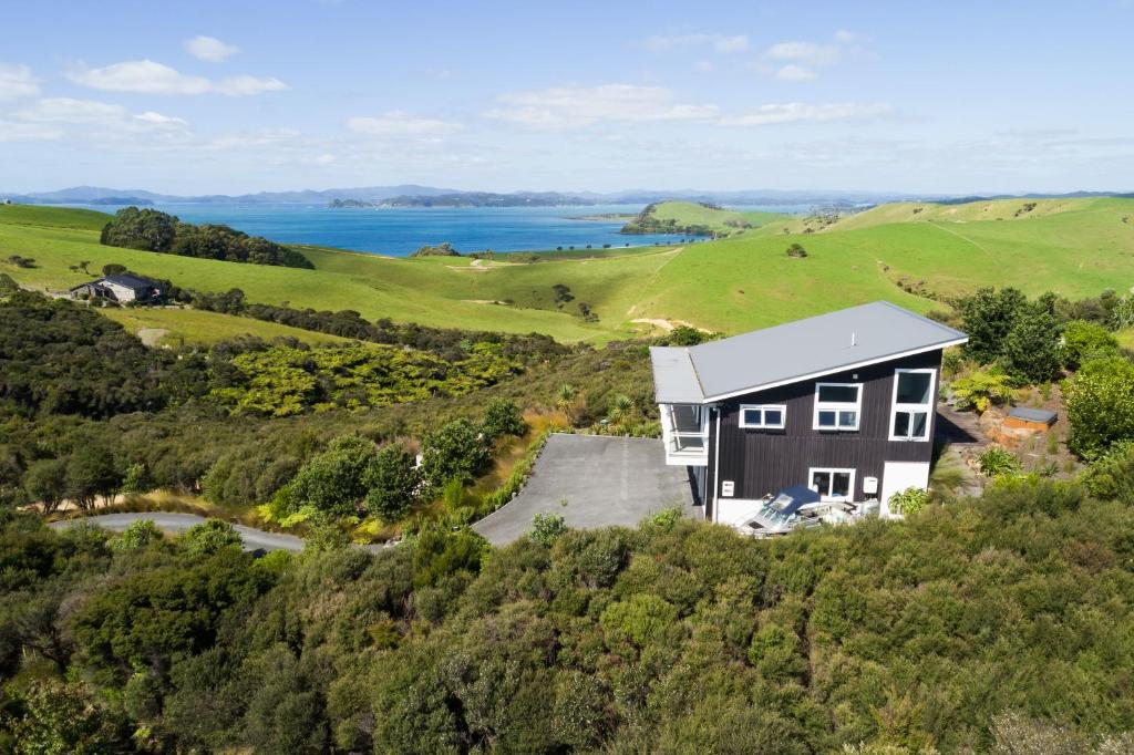 an aerial view of a house on a hill at Wharau Lodge in Kerikeri