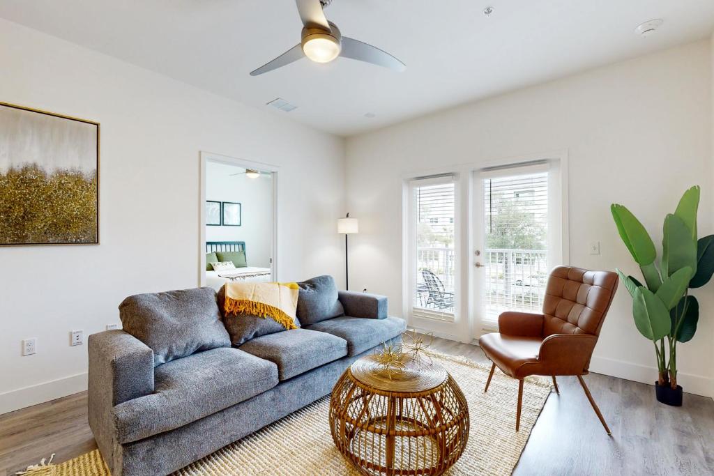 a living room with a couch and a chair at 2 Mi to UF Campus! Modern Luxury Apt w/ Pool in West Hills
