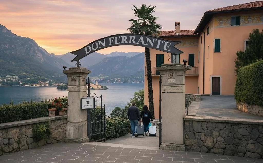 two people walking through an entrance to a building with a sign at Hotel Don Ferrante in Bellagio