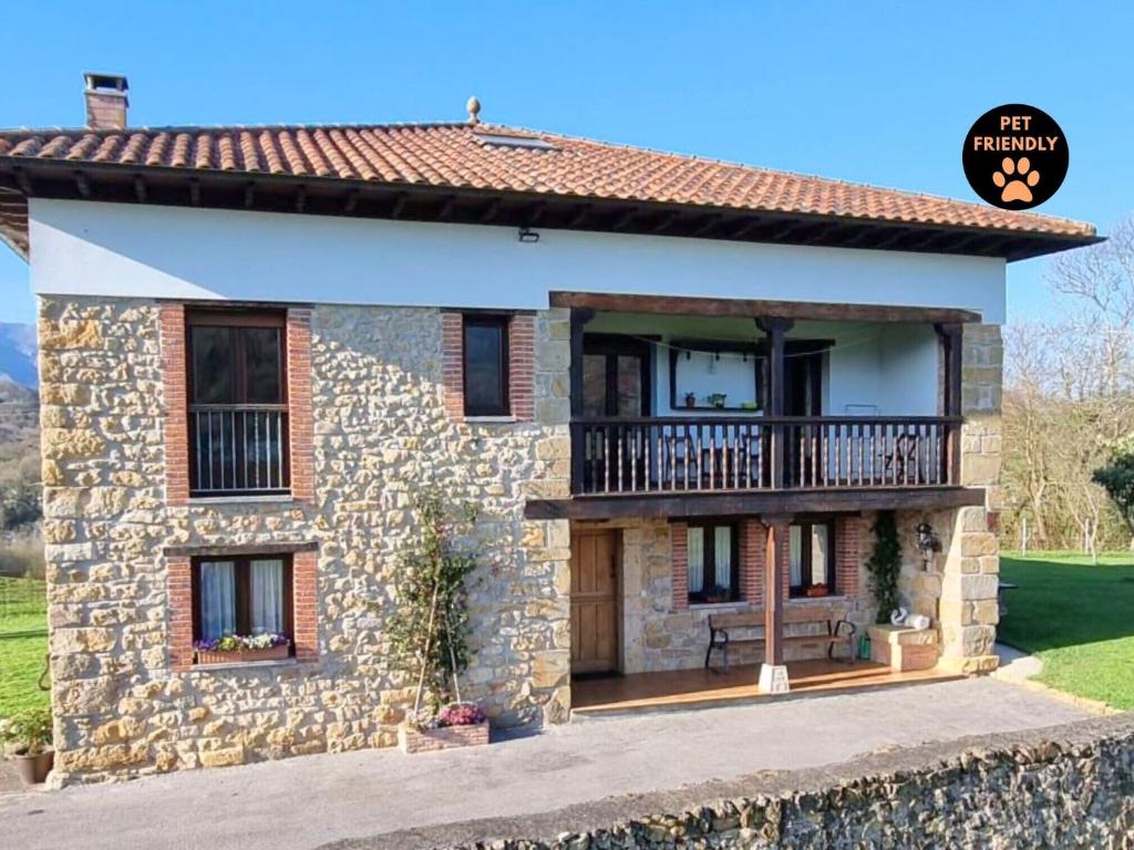 a stone house with a balcony on top of it at La Torre de Llames Arriondas VV-1401-AS in Arriondas