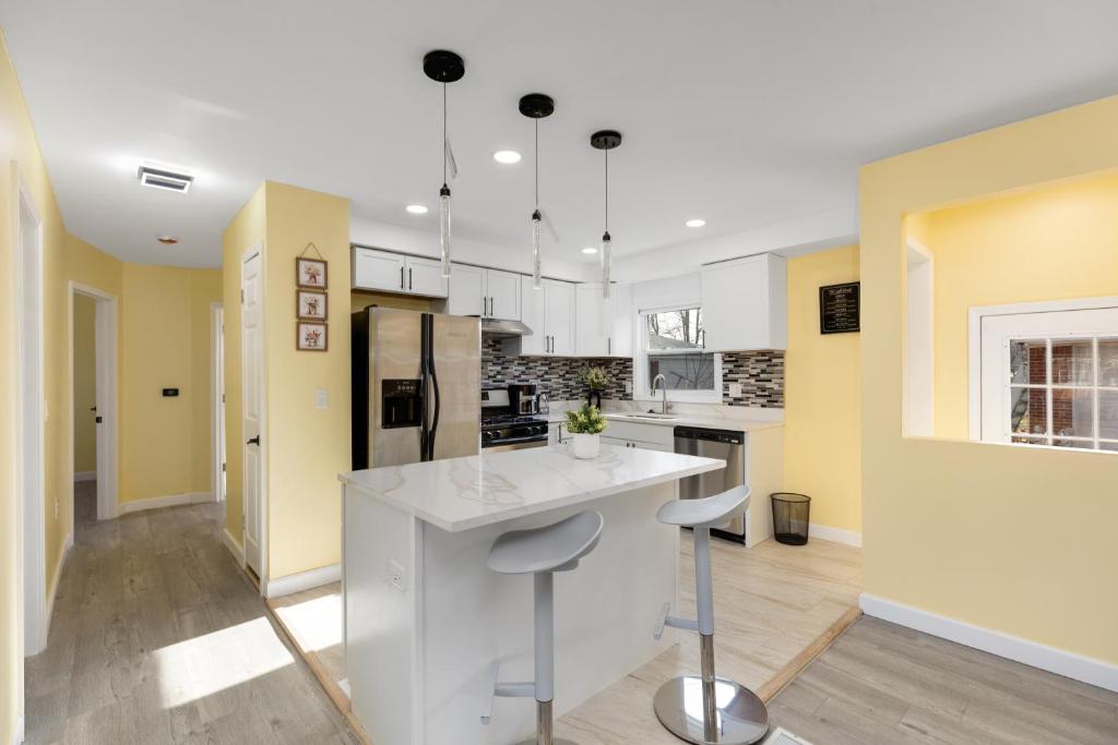 a kitchen with white counters and yellow walls at Furnished Private Room in a Spacious Shared Home#3 in Norton