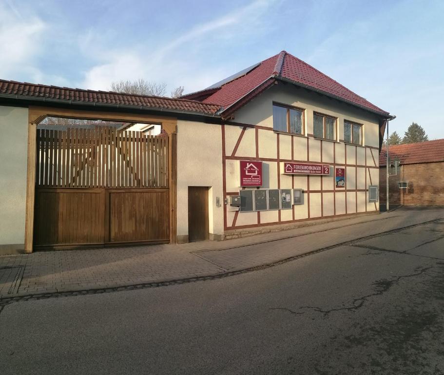 a house with a wooden garage door on a street at Gaestehaus Remde in Erfurt