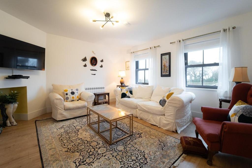 a living room with two couches and a coffee table at Renada Cottage - Dingle Town Centre in Dingle