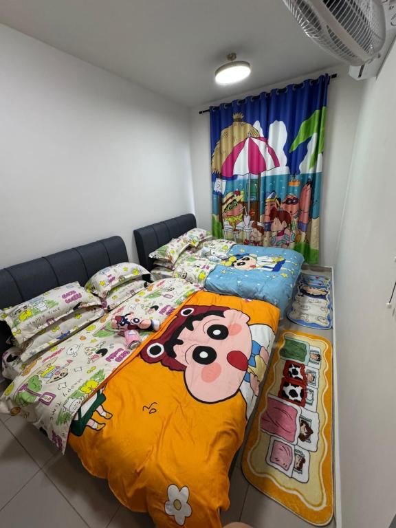 a bedroom with two beds with hello kitty bedding at Shinchan homestay in Skudai