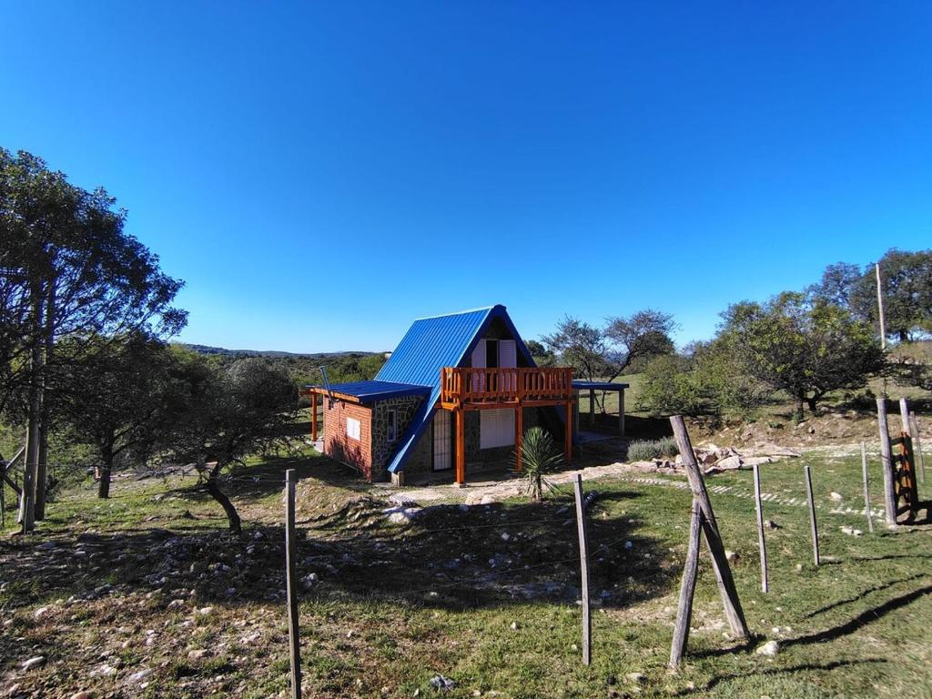 a house on a hill with a playground at Angel Alpino Cabin in Cuesta Blanca