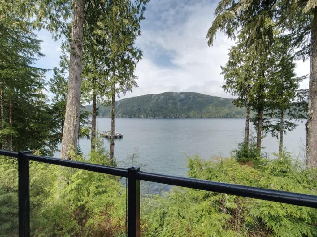 a view of a lake from a balcony at Hera's Cove - Oceanfront Oasis - Pet Friendly in Port Renfrew