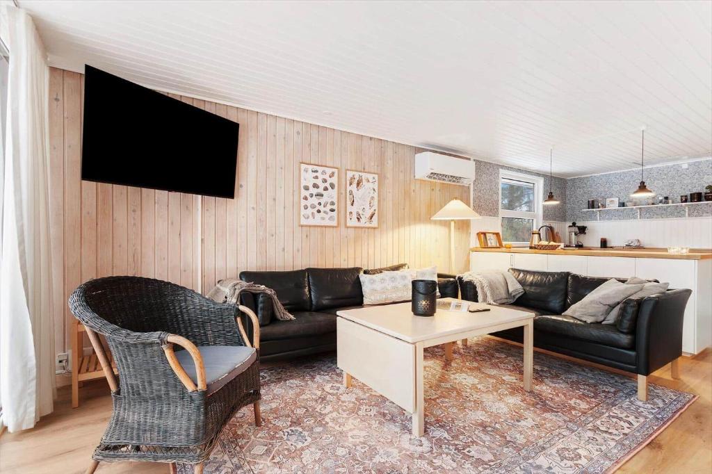 a living room with a couch and a table at TV1706-Bindslev-Uglevej-7 in Tversted