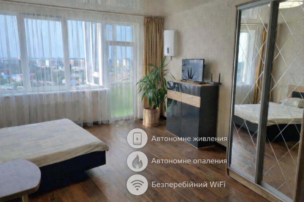 a hotel room with a bed and a window at Apart Panorama in Lviv
