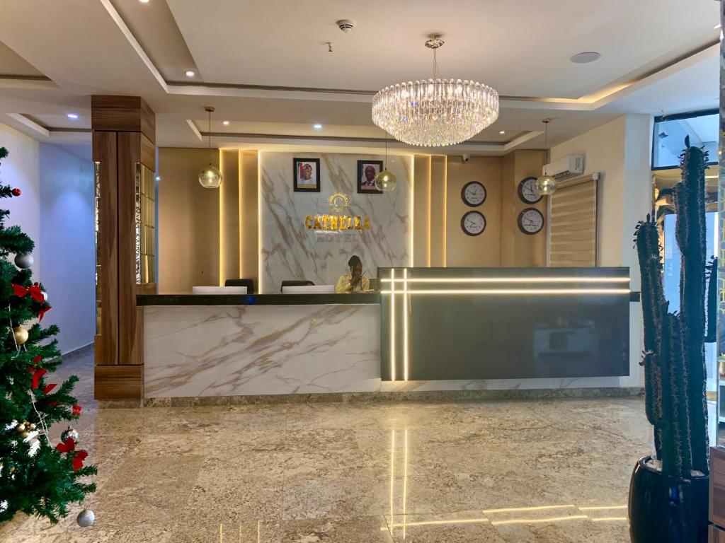 a hotel lobby with a christmas tree in the foreground at Cathelea Convention & Suites in Benin City