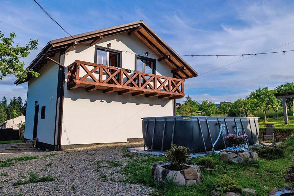 a small house with a wooden balcony on top of it at Jenta in Kyiv