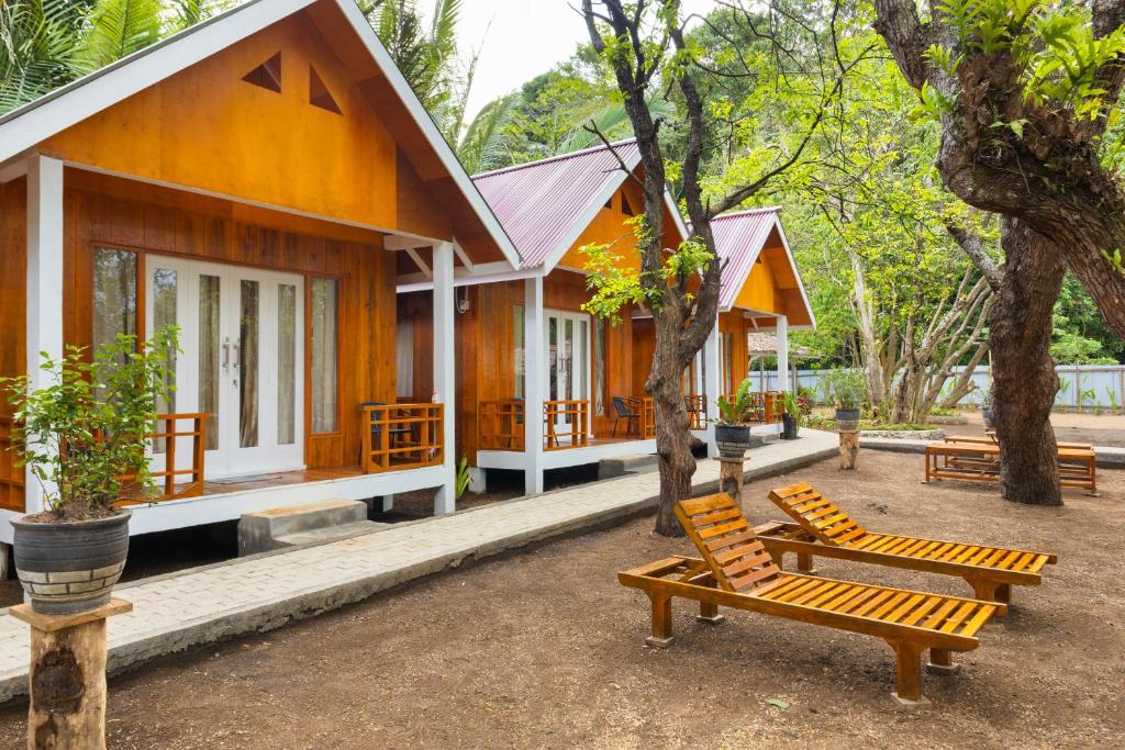 a house with two chairs in front of it at joe Dive resort in Pulau Lembeh