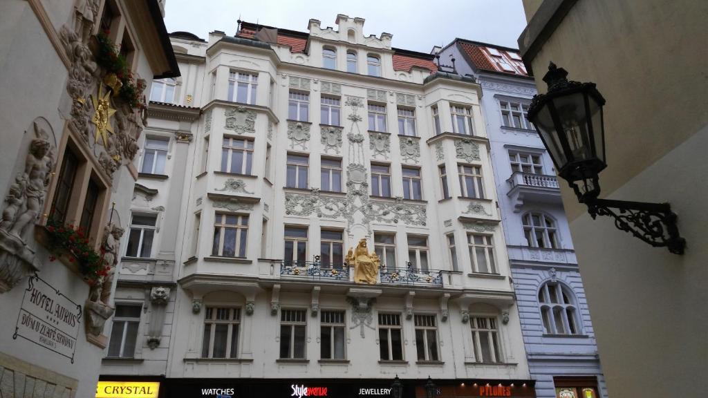 a large white building with a statue in front of it at Charles IV Apartments in Prague