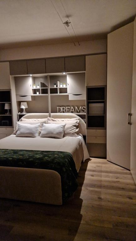 a bedroom with a large bed with white pillows at Bandìtella home in Livorno