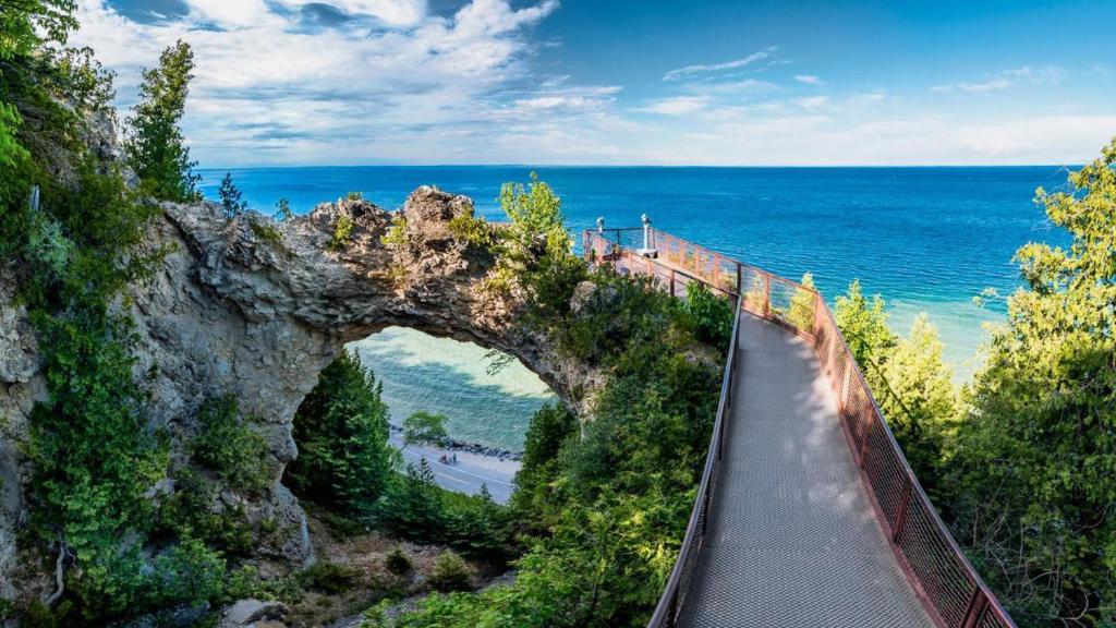 a bridge on a cliff over the ocean at Above Mustang Condos in Mackinac Island