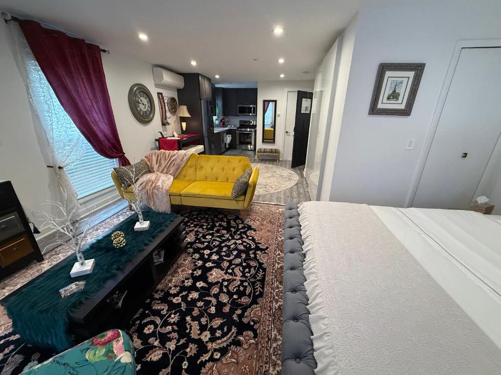 a bedroom with a bed and a couch and a living room at Eleni’s Charming Studio in North Beach