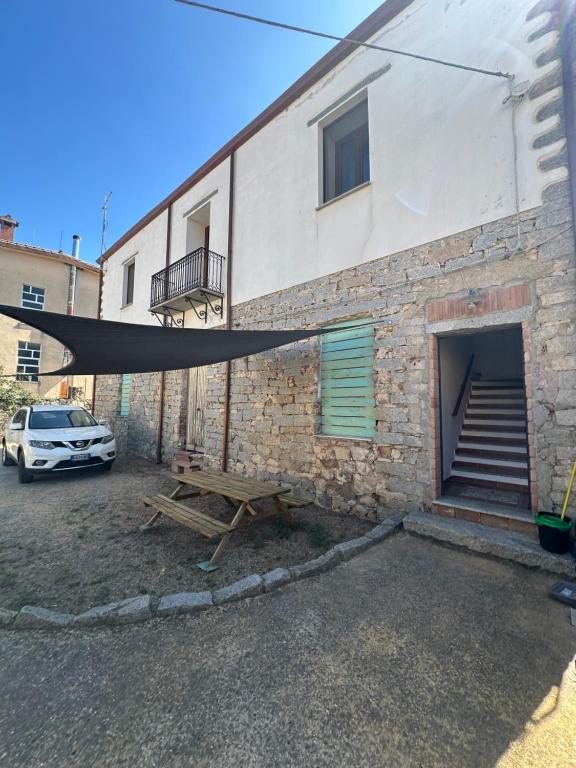 a hammock is attached to the side of a building at La Casa del Corso in Bari Sardo