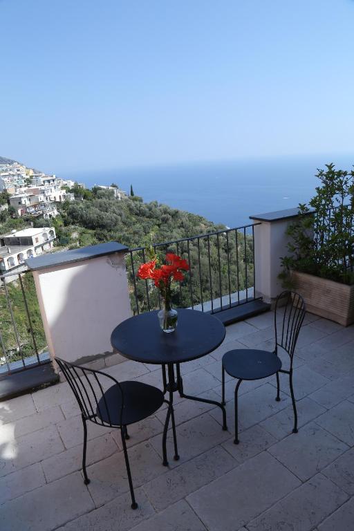 a table and two chairs on a balcony with a view at Casa Maria Grazia in Positano