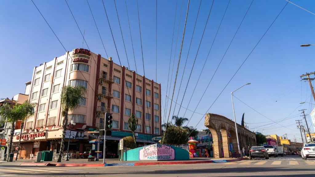 un edificio alto su una strada cittadina con un semaforo di Hotel Nelson a Tijuana