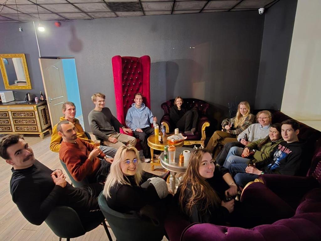 a group of people sitting in a room at Hedgehogs backpackers hostel in Riga
