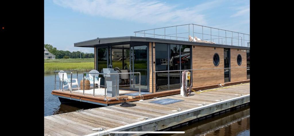a house boat is docked at a dock at Uroczysko Warta in Uniejow