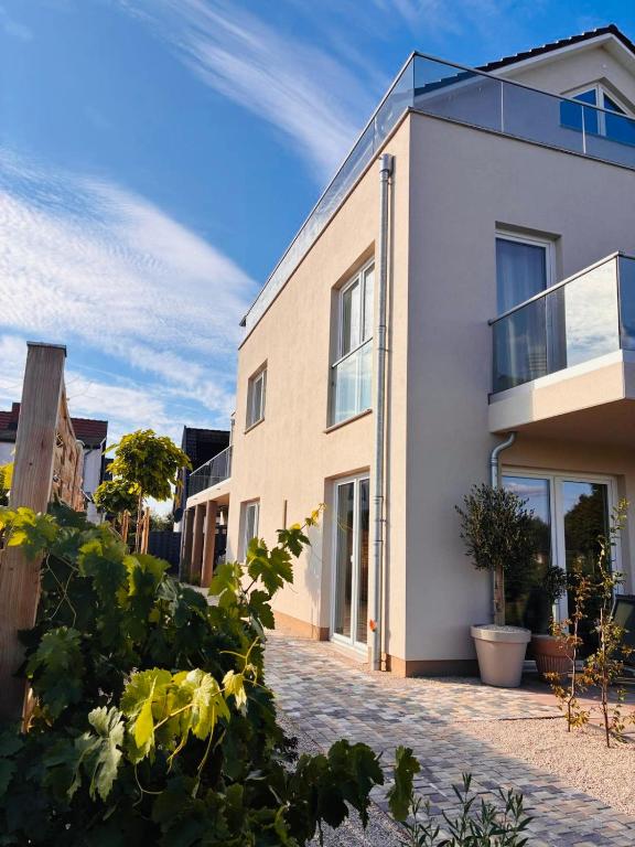 a white house with plants in front of it at Ferienhaus Lounis in Bützow