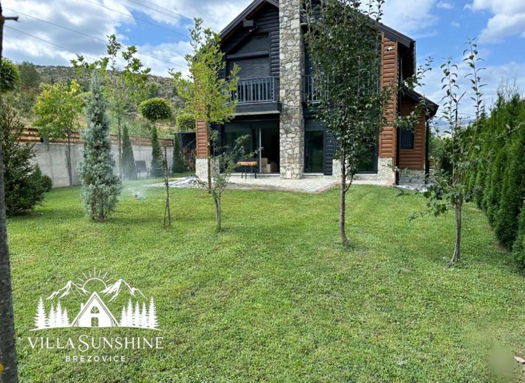 a house with a yard with trees in front of it at Villa Sunshine Brezovicë in Brezovica