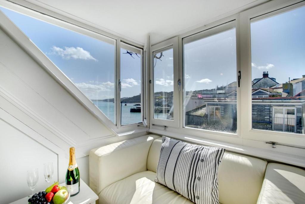 a white couch in a room with windows at 1 Bed in St. Ives oc-cp5 in St Ives