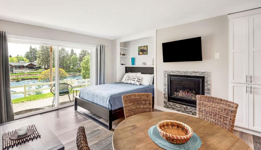 a bedroom with a bed and a fireplace at Riverfront Studio in Downtown Bend in Bend