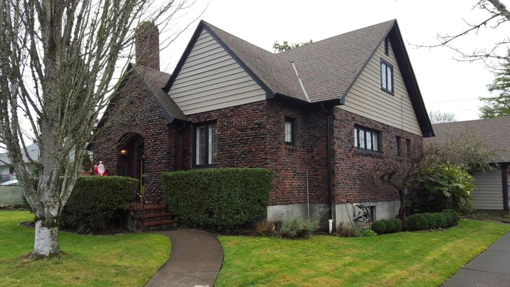 a brick house with a gambrel roof at Clinker Cottage Garden Apartment - Free Breakfast! in Albany