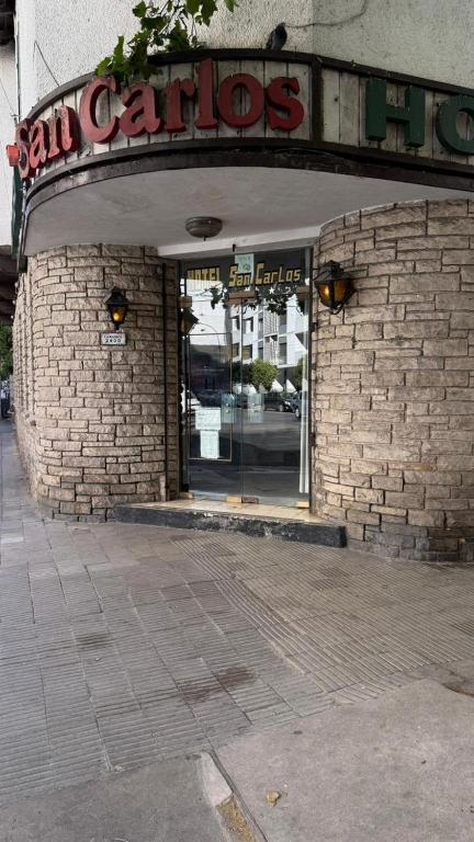 an entrance to a store with a sign on it at Hotel San Carlos in Mar del Plata