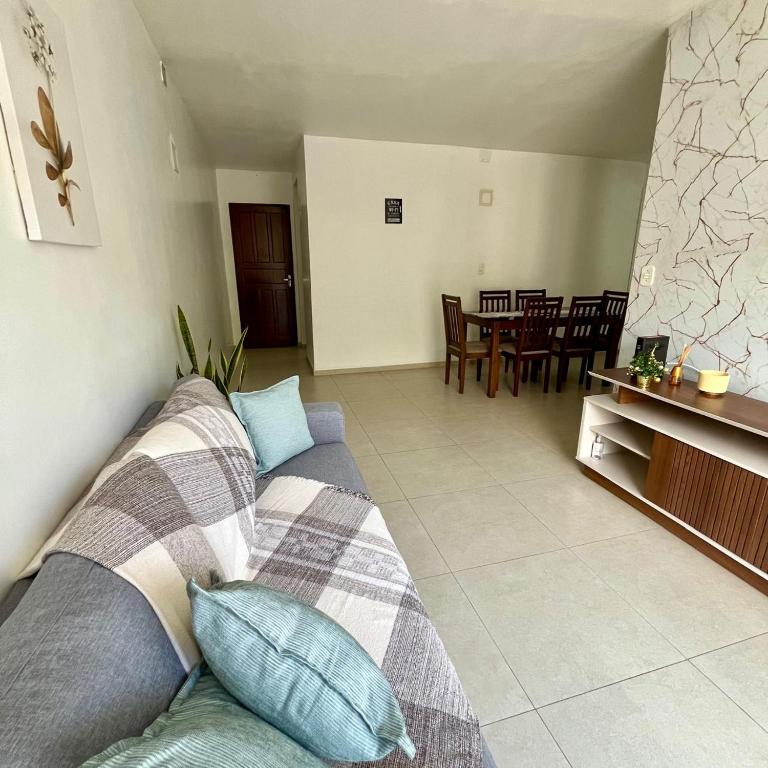 a living room with a couch and a dining room at Cantinho 108 in São Luís