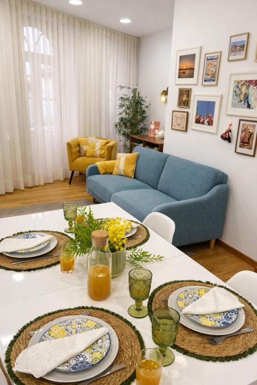 a living room with a table with plates of food at Almeida's House in Viana do Castelo