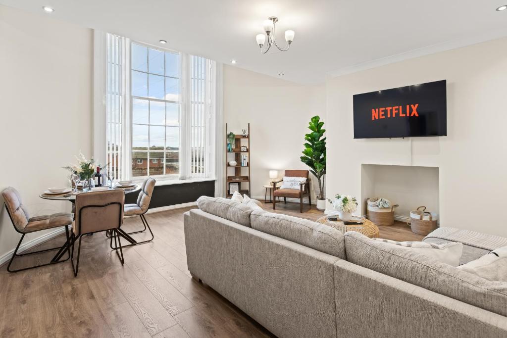a living room with a couch and a table at Spacious 2 Bed Apartment With Secure Free Parking in Liverpool