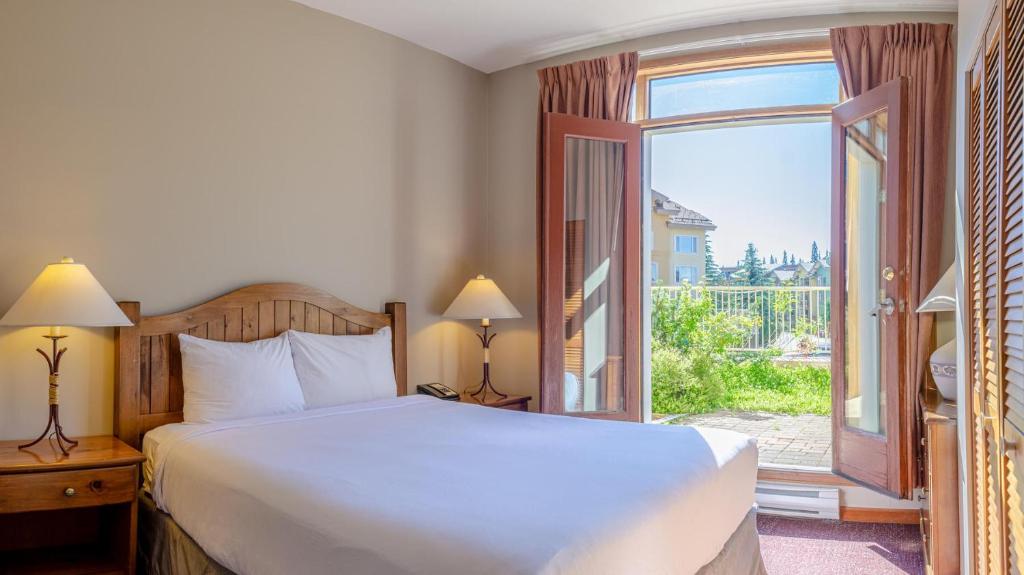 a bedroom with a bed and a large window at Cahilty #110 home in Sun Peaks